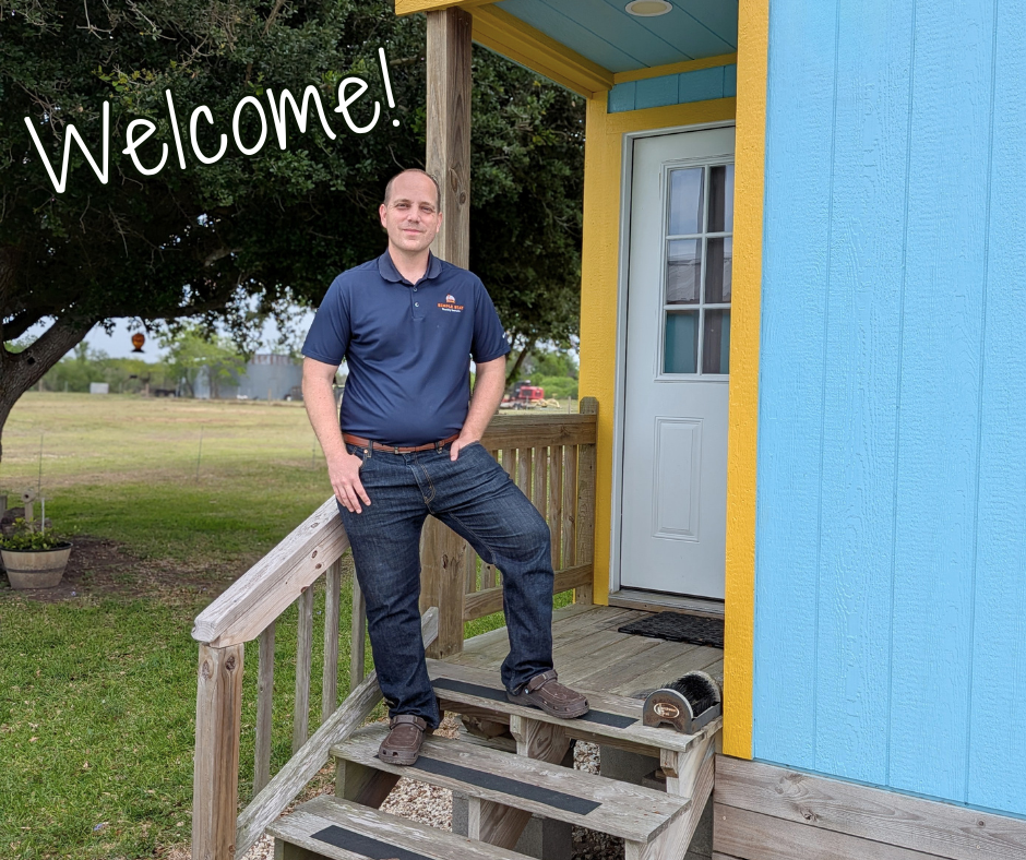 Image of Simple Stay's owner, Ruston, standing on a cabin porch